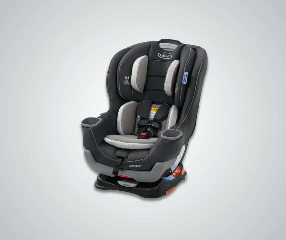 A Graco Extend2Fit 2-in-1 convertible car seat in black and gray, shown with its harness system and infant padding, against a light gray background.